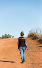 Woman In The Outback Walking Away From Camera