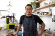 © Jonah Ritchie/Austockphoto - Asian chef working in kitchen at organic food cafe