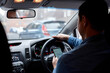 © Jonah Ritchie/Austockphoto - Man driving in his car looking down at mobile phone texting
