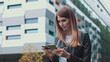 © GRAFStock - Smiling young female customer holding credit card and smartphone, on modern home background. Happy women shoppers using instant simple mobile payments while shopping online. Electronic banking service