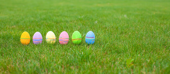 Wall Mural - Colored colorful easter eggs in the grass