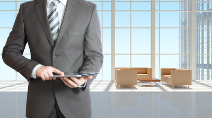 Poster - Businessman with tablet in office building