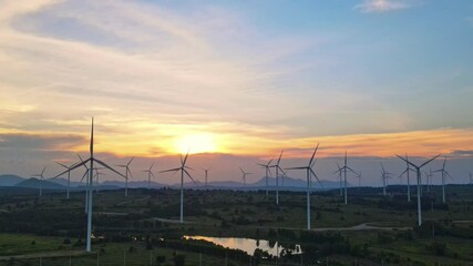 Wall Mural - wind turbines plant for electric power production silhouette at sunset ,clean energy concept