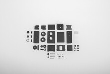 A Completely Deconstructed Knolling Style View Of A Vintage Twin-lens Camera On White Background