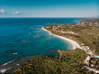 © Pavel - Aerial drone panoramic view of the paradise beach with sandy and rocky shore, palm trees and blue water of Atlantic Ocean, Las Terrenas, Samana, Dominican Republic