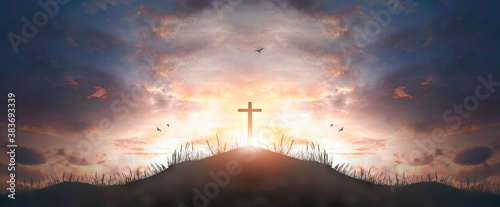 Fotomural cross religion symbol silhouette in grass over sunset sky cross religion symbol