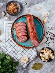 Canvas Print - fresh homemade sausage on a light background with vegetables