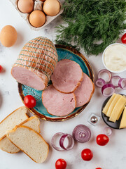 Canvas Print - fresh homemade sausage on a light background with vegetables