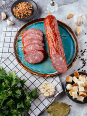 Canvas Print - fresh homemade sausage on a light background with vegetables