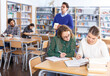 © JackF - Two young female students studying together in university library