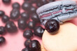 © Lema-lisa - macaroni yellow and blue and decorated with strawberries and blueberries on a pink background, close-up