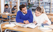 © JackF - Portrait of couple of adult students studying together in public library ..