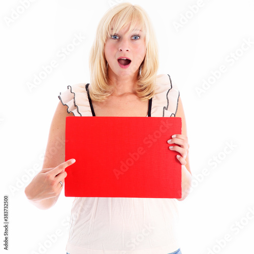 Fotomural Amazed woman pointing to a blank red board Amazed woman pointing to a blank red