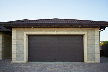 Wall Mural - Modern garage with luxury stone finishes and wide gates for two cars