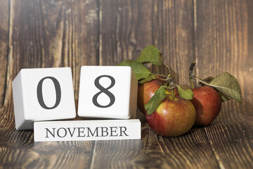 Wall Mural - November 8. Day 08 of month. Calendar cube on wooden background with red apples, concept of business and an important event. Autumn season.