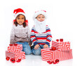 Little kids in Santa's hat with gift box