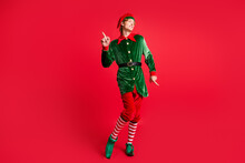 Full Length Photo Of Handsome X-mas North-pole Jolly Elf Dance Wear X-mas Costume Isolated Red Bright Color Background