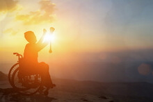 Silhouette Of Disabled Person On Wheelchair Sunset Background. International Disability Day Or Handicapped Sport. Life In The Education Age Of Special Syndrome Children, Autistic Awareness Day Concept