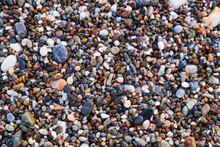 Background Of Colored Sea Pebbles On The Beach Of Alanya, Turkey. Seamless Texture