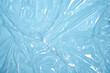© troyanphoto - Clear plastic texture with blue color. Nylon polythene wrap. Plastic free lifestyle, ecology pollution
