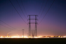 Silhouette Of Electricity Pylon At Dusk