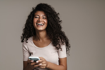 Poster - Smiling woman with afro hairstyle typing text message