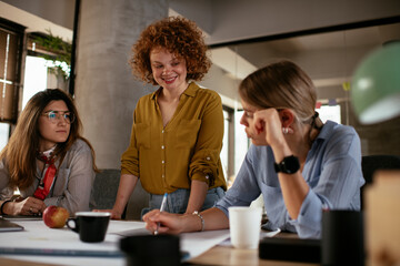 Poster - Businesswomen working on a new project. Colleagues discussing work in office.