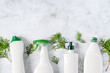 Set of different bottles of bio organic detergent  for home cleaning top view on grey concrete background.