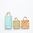 © Sanga - Paper shopping bags on white background. top view, copy space
