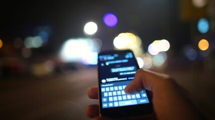 Poster - Sending a text message using your phone. The hand holds the gadget, types words on the keyboard. The phone screen glows in the evening. Pistol communication of people.