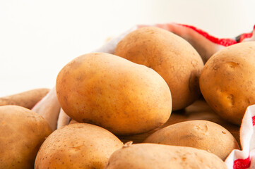 Wall Mural - stack of potatoes close up on kitchen table