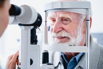 Wall Mural - Close up photo of smiling senior male patient during sight examination