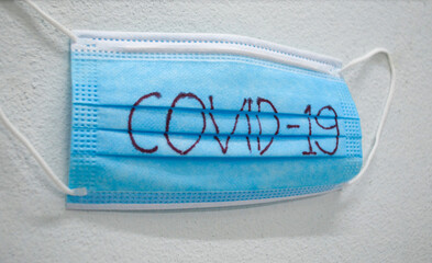 surgical mask for protection pm 2.5 and corona virus (covid-19) with white background.surgical mask with red blood covid-19 word. Hygienic mask.