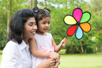 Wall Mural - parent and child playing windmill