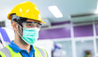 © winnievinzence - Portrait of male engineer worker wearing protective face mask, safety helmet and glasses at factory. industrial plant and new normal working. man standing and look forward, copy space