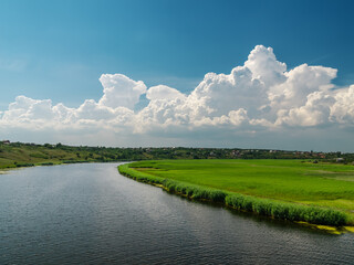 Canvas Print - white clouds over river