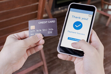 Online shopping, mobile payment. Woman hands holding credit card and using smart phone for online payment