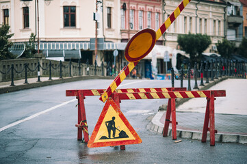 Reconstruction of the city street. Arrangement of atmospheric sewerage. Protective fence and warning signs on the part of the street that was excavated due to the replacement of old sewer pipes. 