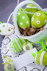 Canvas Print - Colourful green Easter eggs in straw