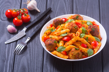 Canvas Print - Italian penne pasta with meatballs and tomatoes