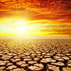 Poster - red sunset over drought earth