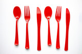 Fototapeta  - Single use red plastic cutlery on a white background. Concept: Ban single use plastic