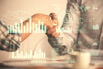 Double exposure of forex graph hologram and handshake of two men. Stock market concept.