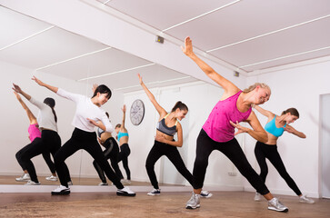 Wall Mural - Women dancing aerobics at lesson in the dance class. High quality photo