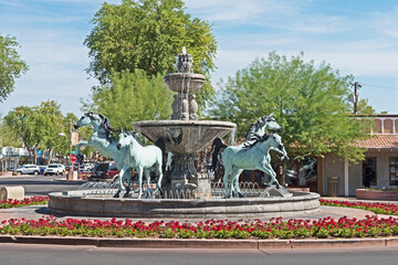 A bronze horse fountain situated in a central square in Old Town Scottsdale, Arizona.