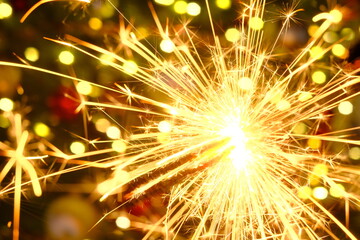 Sticker - Bengal light.Sparkler sparks.Christmas and new year festive background. Bengal fire on a festive Christmas tree on blurred background.Winter holidays beautiful background.