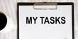 © Veranika - Business concept. Tablet for writing with text MY TASKS, coffee, reports.