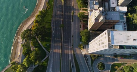 Wall Mural - Aerial overhead view of multi lanes road and tall buildings by the beach in Chicago Downtown. Early morning light.