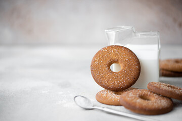 round shortbread cookies with sugar and cold milk