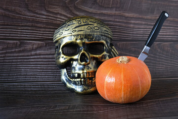 Wall Mural - pumpkin and skull on wooden background